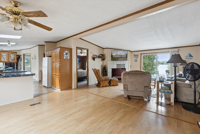 9168 Clewley Rd, Lachine, MI 49753 - living room featuring ornamental molding, ceiling fan, light wood-style flooring, healthy amount of natural light, and lofted ceiling