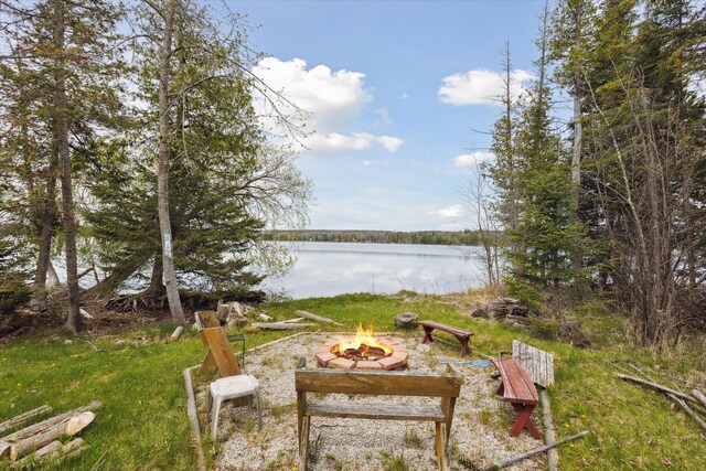 9168 Clewley Rd, Lachine, MI 49753 - view of yard featuring an outdoor fire pit and a water view