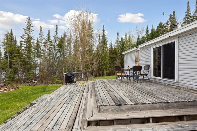 9168 Clewley Rd, Lachine, MI 49753 - wooden terrace featuring outdoor dining space and a yard