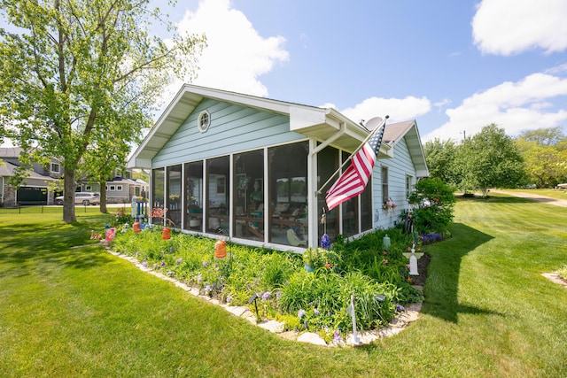 65805 S St, Cassopolis, MI 49031 - view of side of home with a sunroom and a yard