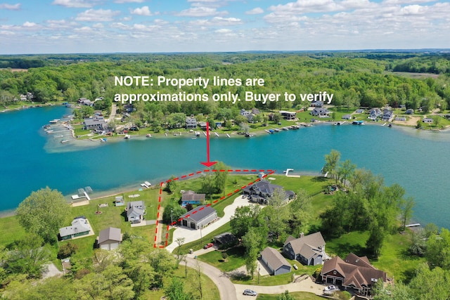 65805 S St, Cassopolis, MI 49031 - aerial view of residential area featuring a heavily wooded area, property parcel outlined, and a large body of water