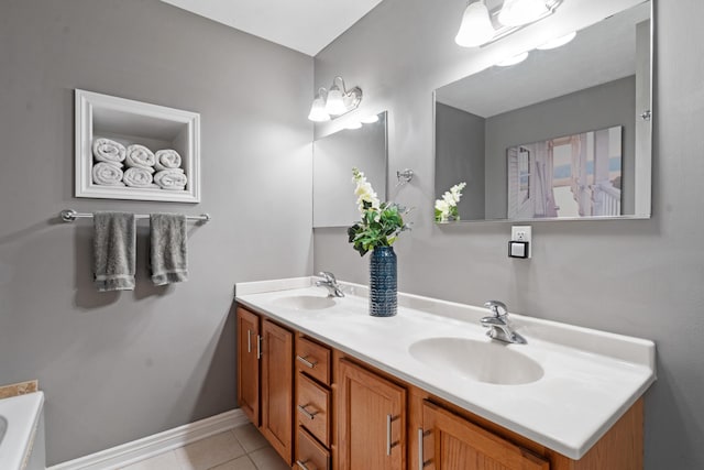 24346 Vargas Dr, Mattawan, MI 49071 - bathroom featuring tile patterned flooring, double vanity, a tub, and baseboards