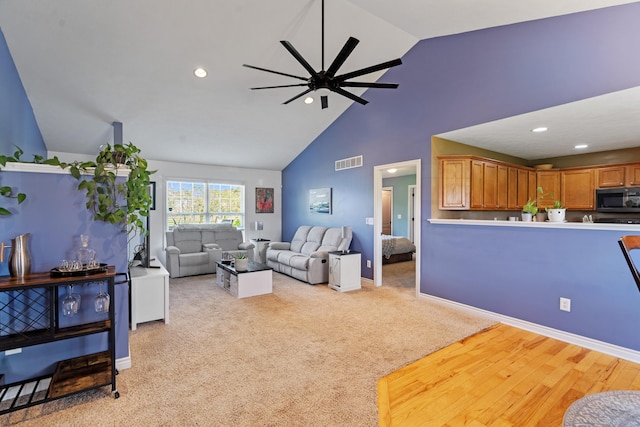 24346 Vargas Dr, Mattawan, MI 49071 - living room with ceiling fan, recessed lighting, high vaulted ceiling, light colored carpet, and baseboards