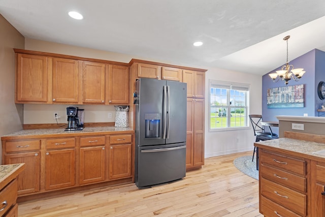 24346 Vargas Dr, Mattawan, MI 49071 - kitchen with stainless steel fridge, brown cabinets, light countertops, recessed lighting, and vaulted ceiling