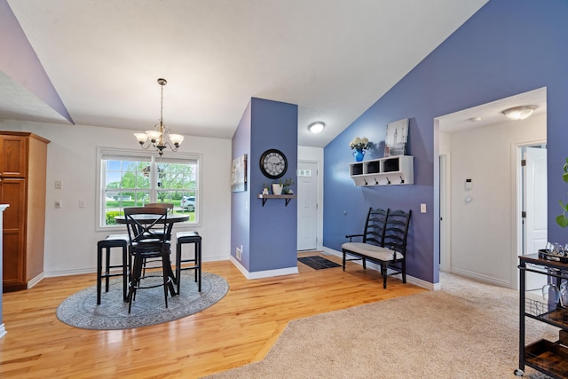 24346 Vargas Dr, Mattawan, MI 49071 - dining room with vaulted ceiling, a chandelier, light wood-style floors, and baseboards