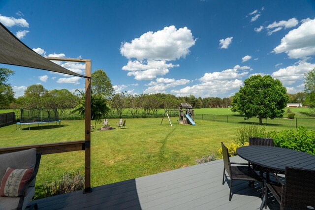 24346 Vargas Dr, Mattawan, MI 49071 - deck with a trampoline, a playground, and outdoor dining area