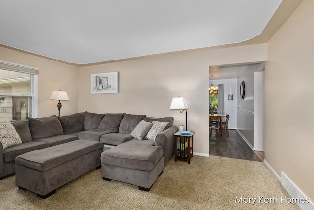 756 66th St SE, Grand Rapids, MI 49548 - carpeted living room with a chandelier and baseboards