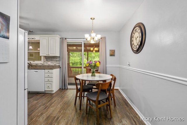 756 66th St SE, Grand Rapids, MI 49548 - dining space with a chandelier, dark wood finished floors, and baseboards