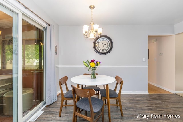 756 66th St SE, Grand Rapids, MI 49548 - dining space with wood finished floors, a chandelier, and baseboards