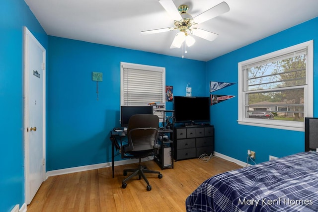 756 66th St SE, Grand Rapids, MI 49548 - bedroom with wood finished floors, baseboards, an office area, and a ceiling fan