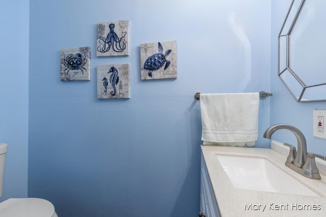 756 66th St SE, Grand Rapids, MI 49548 - half bathroom featuring toilet and vanity