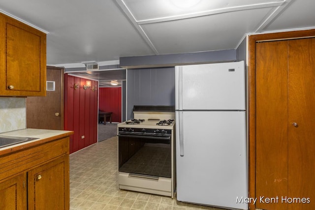 756 66th St SE, Grand Rapids, MI 49548 - kitchen with white appliances, brown cabinetry, light countertops, and light floors