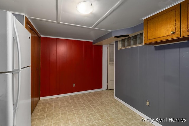 756 66th St SE, Grand Rapids, MI 49548 - finished below grade area featuring freestanding refrigerator, light floors, and wooden walls