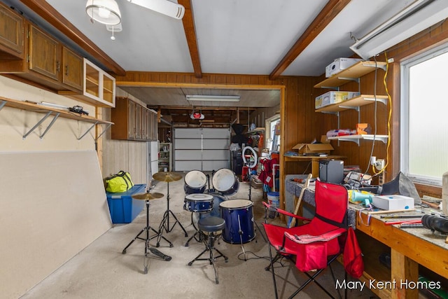 756 66th St SE, Grand Rapids, MI 49548 - garage with wood walls and a garage door opener
