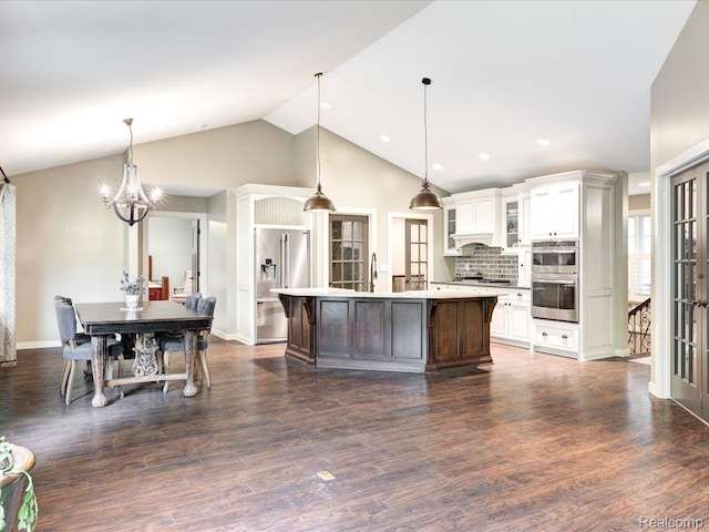 5076 Birch Ave, Lexington, MI 48450 - kitchen featuring stainless steel appliances, light countertops, a chandelier, white cabinetry, and glass insert cabinets