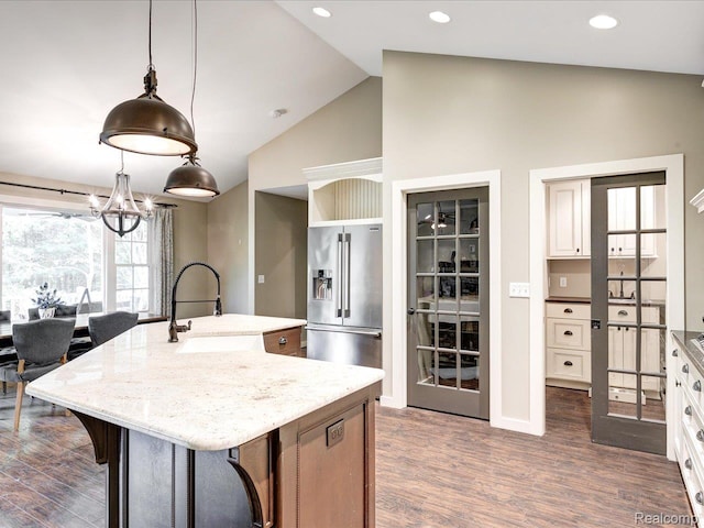 5076 Birch Ave, Lexington, MI 48450 - kitchen with high end refrigerator, a sink, light stone counters, dark wood-style floors, and a kitchen island with sink