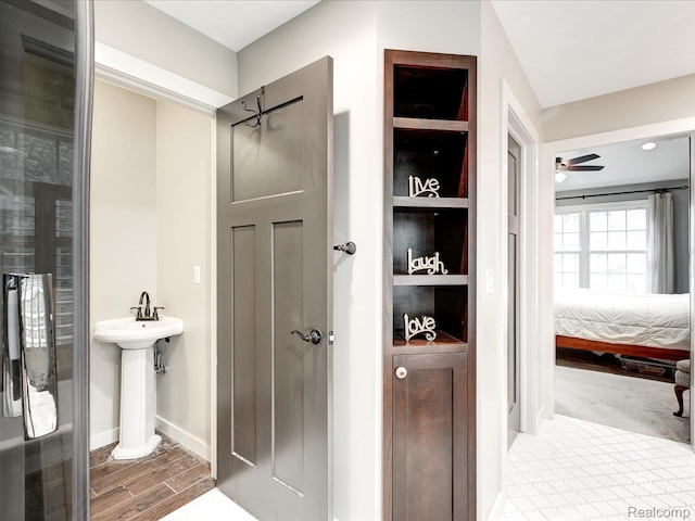5076 Birch Ave, Lexington, MI 48450 - ensuite bathroom with a ceiling fan, a sink, baseboards, and wood finished floors
