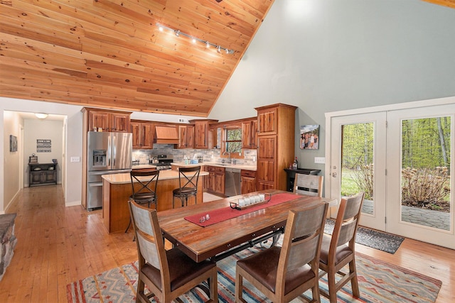 5301 Durga Rd, Williamsburg, MI 49690 - dining room with high vaulted ceiling, light wood-style flooring, wood ceiling, and track lighting