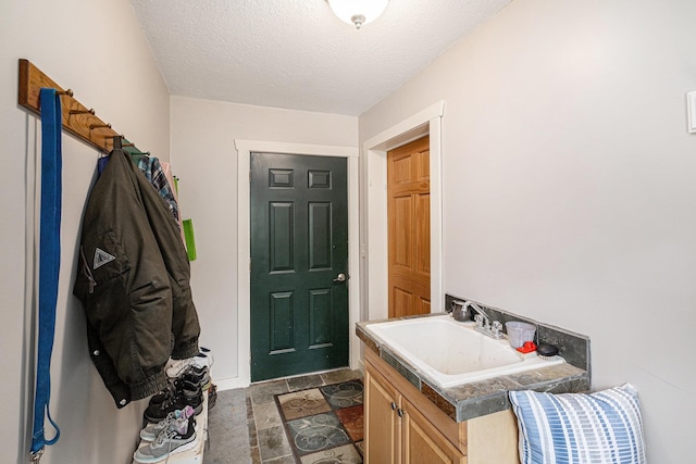 5301 Durga Rd, Williamsburg, MI 49690 - bathroom with a textured ceiling and vanity