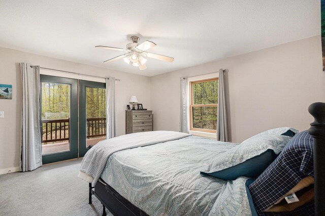 5301 Durga Rd, Williamsburg, MI 49690 - bedroom featuring access to outside, light carpet, a ceiling fan, and baseboards