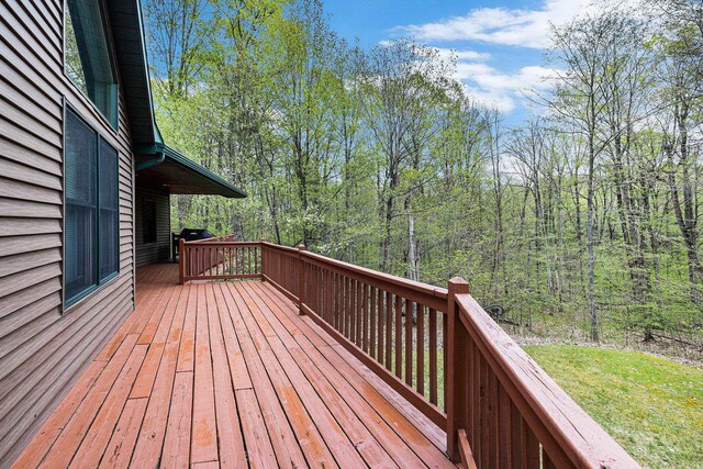 5301 Durga Rd, Williamsburg, MI 49690 - wooden terrace featuring a view of trees