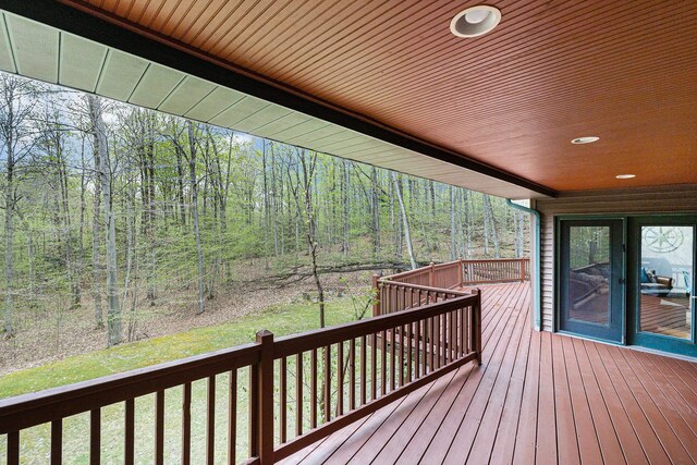 5301 Durga Rd, Williamsburg, MI 49690 - wooden terrace featuring a view of trees and a yard