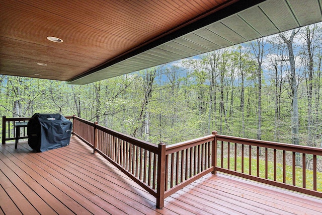 5301 Durga Rd, Williamsburg, MI 49690 - wooden terrace featuring a view of trees and a grill