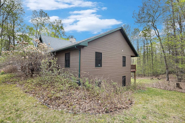 5301 Durga Rd, Williamsburg, MI 49690 - view of home's exterior with a chimney