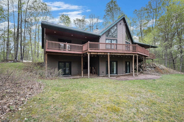 5301 Durga Rd, Williamsburg, MI 49690 - rear view of property with a wooden deck, a lawn, and french doors