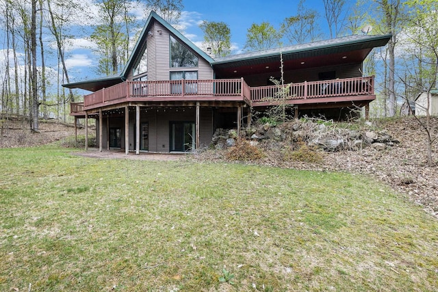 5301 Durga Rd, Williamsburg, MI 49690 - rear view of property featuring a wooden deck and a lawn