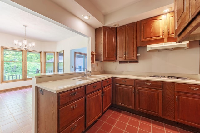 10109 Lauer Rd, Baroda, MI 49101 - kitchen with a sink, dark tile patterned flooring, a peninsula, light countertops, and brown cabinetry