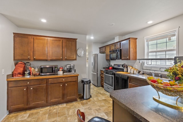 165LOT220 S Opdyke Rd, Auburn Hills, MI 48326 - kitchen featuring black appliances, recessed lighting, a sink, brown cabinetry, and dark countertops