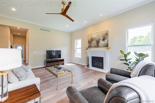 21377 Stone Meadow Dr, Northville, MI 48167 - living room featuring ceiling fan, crown molding, light wood-style flooring, a fireplace with flush hearth, and recessed lighting