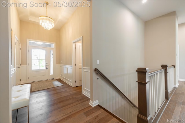 21377 Stone Meadow Dr, Northville, MI 48167 - entrance foyer featuring a chandelier, wood finished floors, a wainscoted wall, and a decorative wall