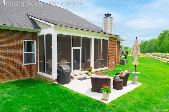21377 Stone Meadow Dr, Northville, MI 48167 - rear view of property featuring a sunroom, brick siding, a chimney, and central air condition unit