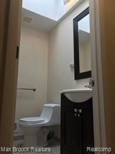 4139 Yorba Linda Blvd, Royal Oak, MI 48073 - bathroom featuring toilet, vanity, and a skylight