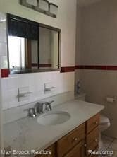 4139 Yorba Linda Blvd, Royal Oak, MI 48073 - bathroom featuring toilet, vanity, and tile patterned flooring
