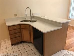 4139 Yorba Linda Blvd, Royal Oak, MI 48073 - kitchen featuring a sink, dishwasher, light countertops, light tile patterned floors, and baseboards