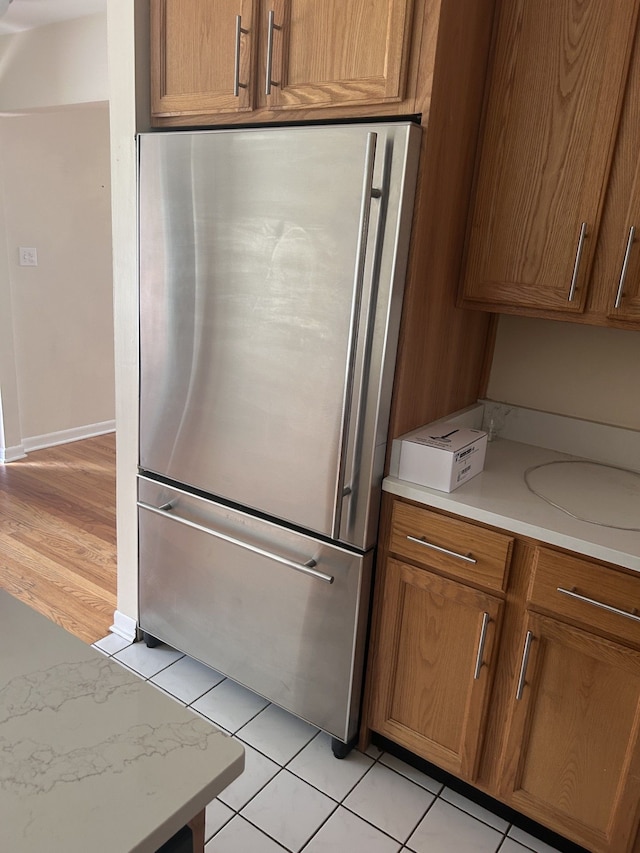 4139 Yorba Linda Blvd, Royal Oak, MI 48073 - kitchen with stainless steel refrigerator, light countertops, brown cabinetry, and light tile patterned floors