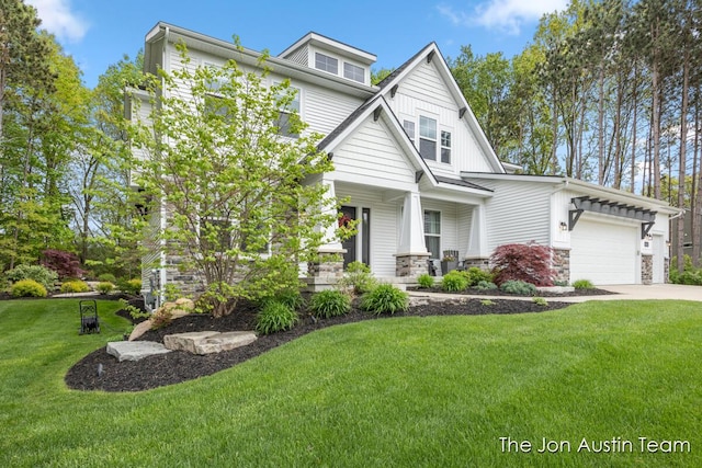 9012 N Wolven Ridge Ct, Rockford, MI 49341 - view of front of house with a front yard, an attached garage, driveway, and stone siding