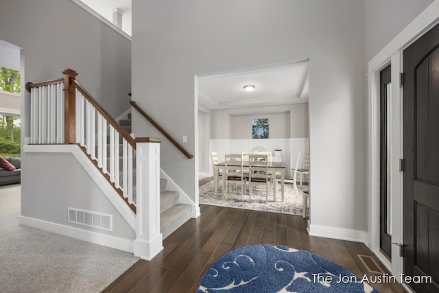 9012 N Wolven Ridge Ct, Rockford, MI 49341 - foyer entrance featuring wood finished floors, stairway, a towering ceiling, and baseboards