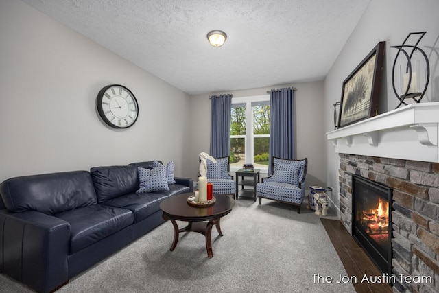 9012 N Wolven Ridge Ct, Rockford, MI 49341 - living area featuring a stone fireplace, a textured ceiling, and dark wood-type flooring