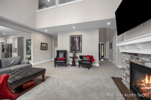 9012 N Wolven Ridge Ct, Rockford, MI 49341 - living room featuring carpet flooring, recessed lighting, baseboards, a fireplace, and a towering ceiling