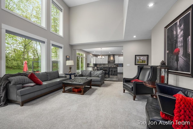 9012 N Wolven Ridge Ct, Rockford, MI 49341 - living area with carpet floors, a chandelier, recessed lighting, and a high ceiling