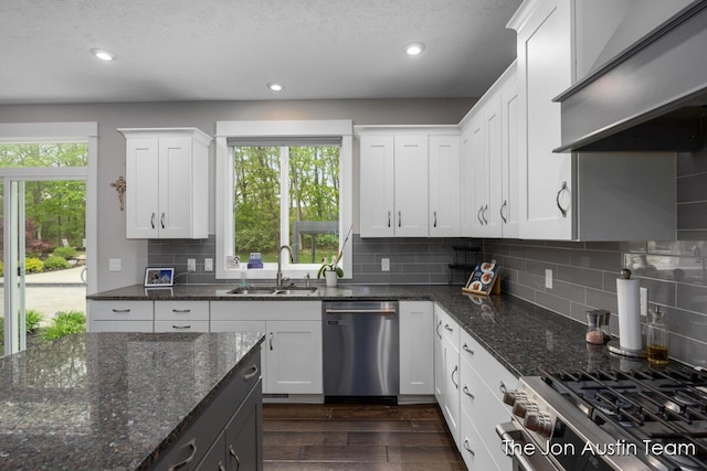 9012 N Wolven Ridge Ct, Rockford, MI 49341 - kitchen with appliances with stainless steel finishes, a sink, recessed lighting, dark wood-style floors, and wall chimney range hood