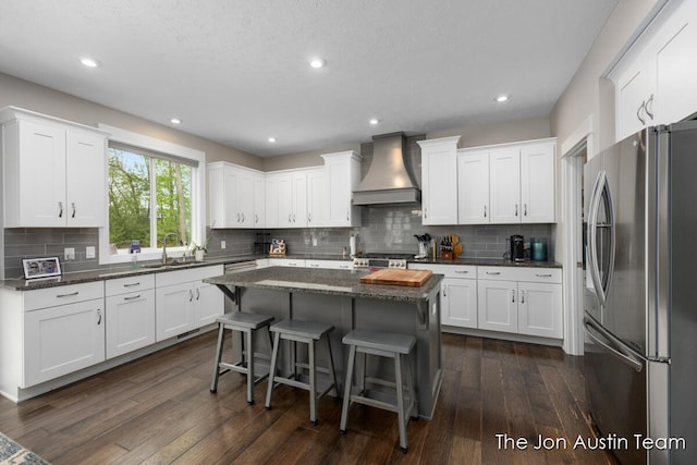 9012 N Wolven Ridge Ct, Rockford, MI 49341 - kitchen featuring stainless steel appliances, premium range hood, a sink, white cabinetry, and recessed lighting