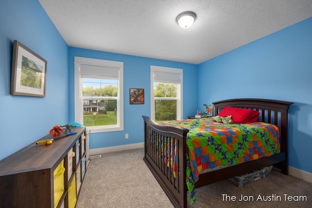 9012 N Wolven Ridge Ct, Rockford, MI 49341 - bedroom featuring carpet flooring, baseboards, and a textured ceiling