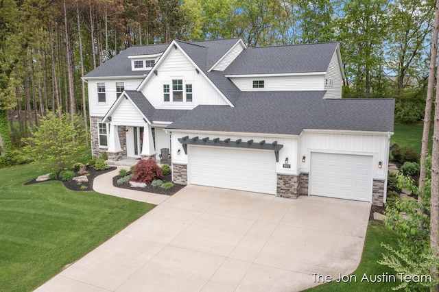 9012 N Wolven Ridge Ct, Rockford, MI 49341 - view of front of house featuring stone siding, driveway, a shingled roof, a front yard, and an attached garage