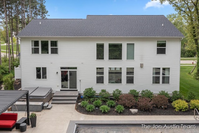 9012 N Wolven Ridge Ct, Rockford, MI 49341 - back of property featuring a patio and roof with shingles