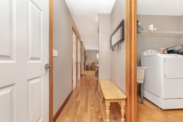 6833 Strawberry Lake Rd, Whitmore Lake, MI 48189 - washroom with washer / dryer and light wood-type flooring